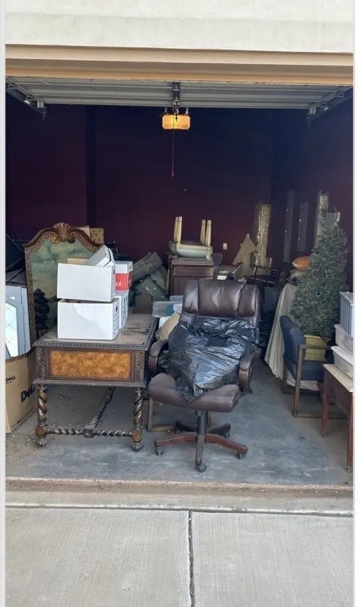Cluttered garage full of junk before removal